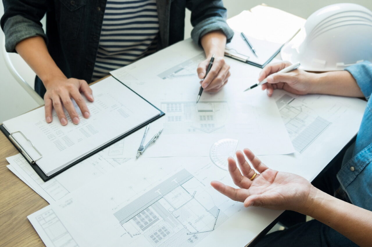 Engineer discussing meeting working on blueprint project architectural at construction site